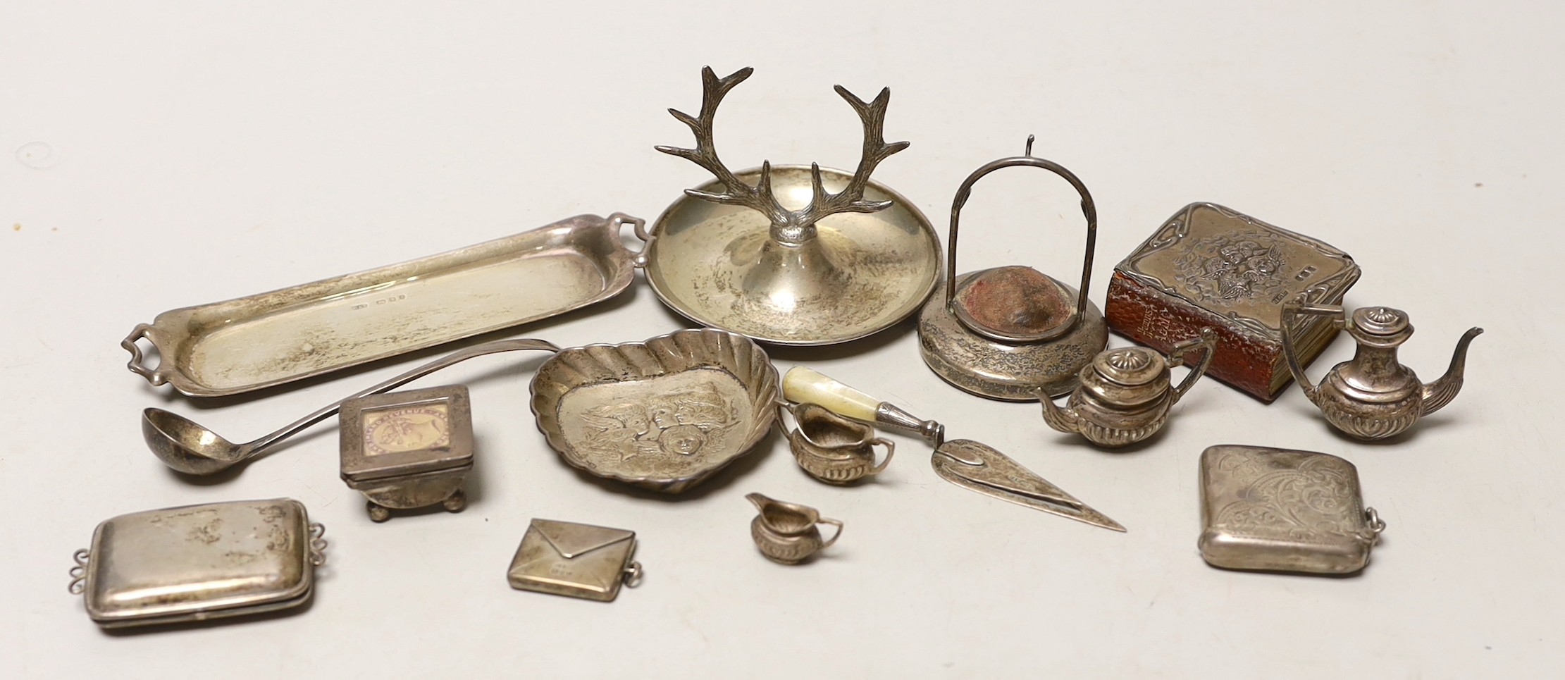 A small quantity of sundry collectable silver including a modern miniature four piece tea set of tray, a watch stand and ring tree, two stamp boxes, mounted bible, vesta case, one other case, a bookmark, dish and mustard